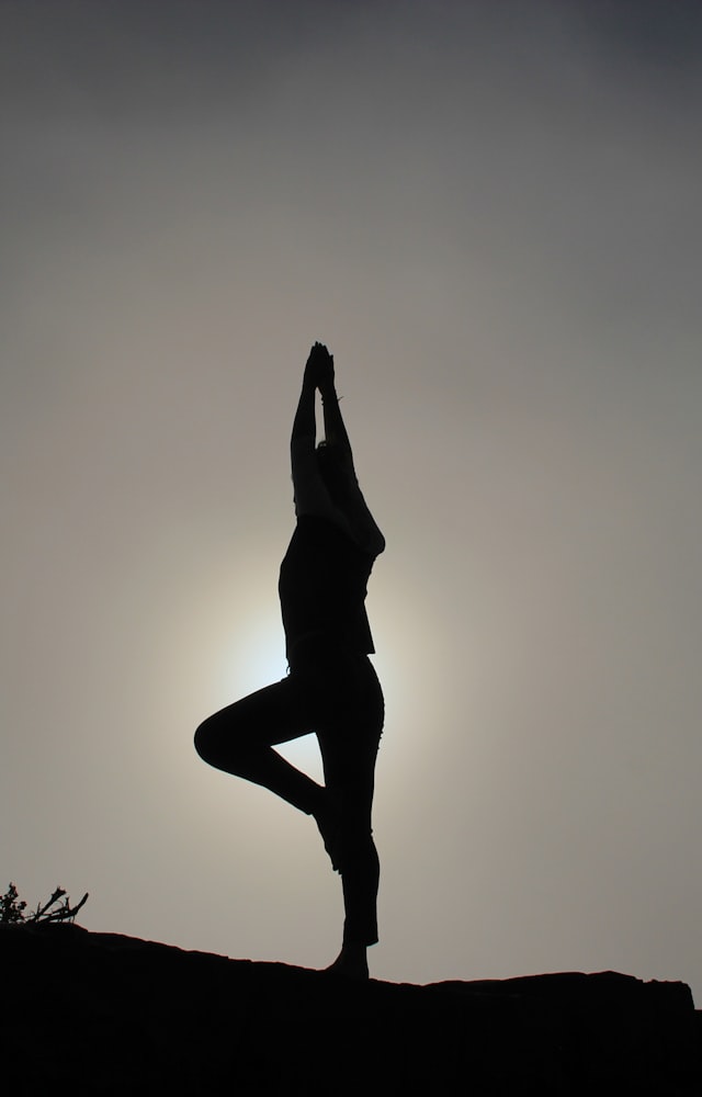 Figure with arms raised toward the sun